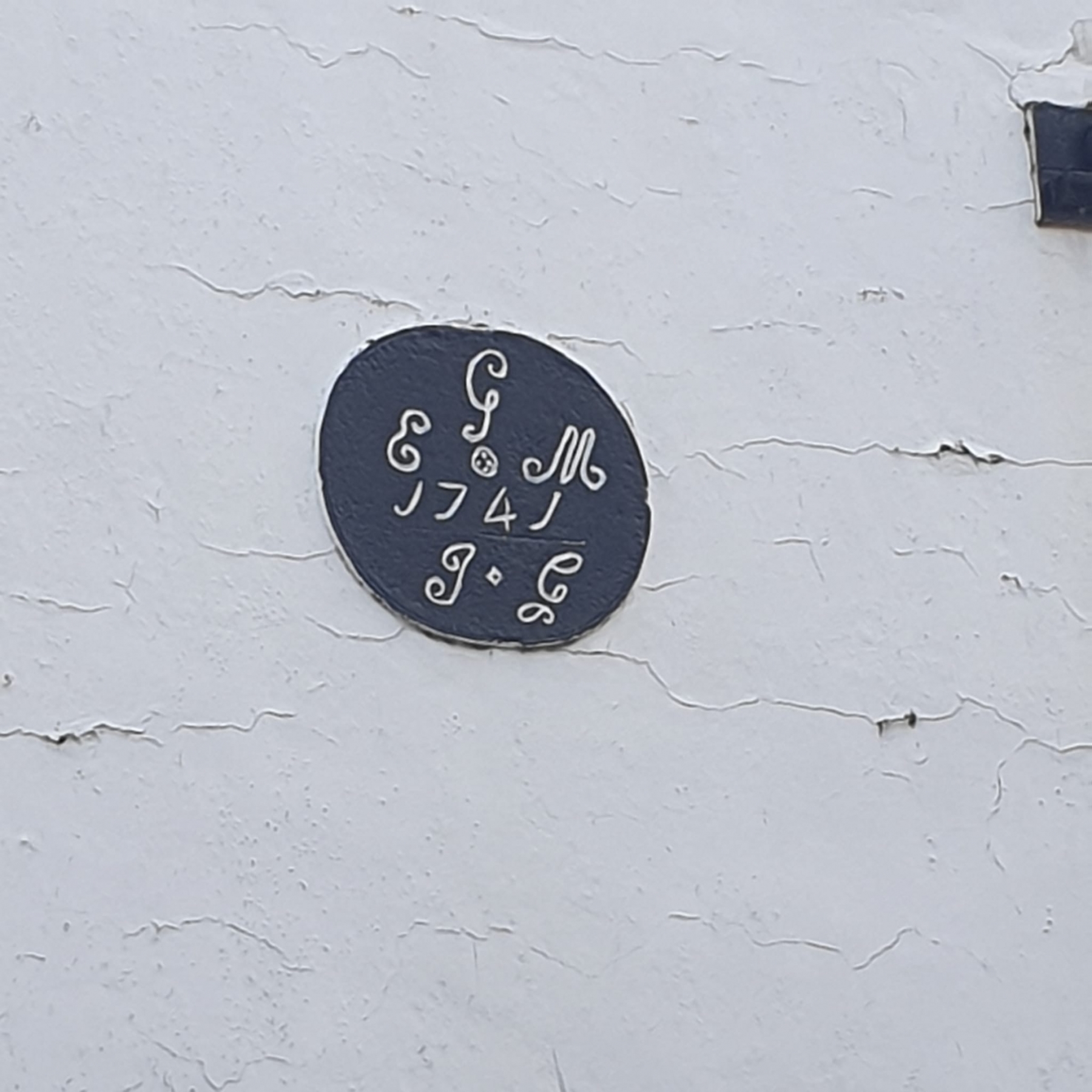 Detail of house showing placard reading 'G.E.M. 1741'