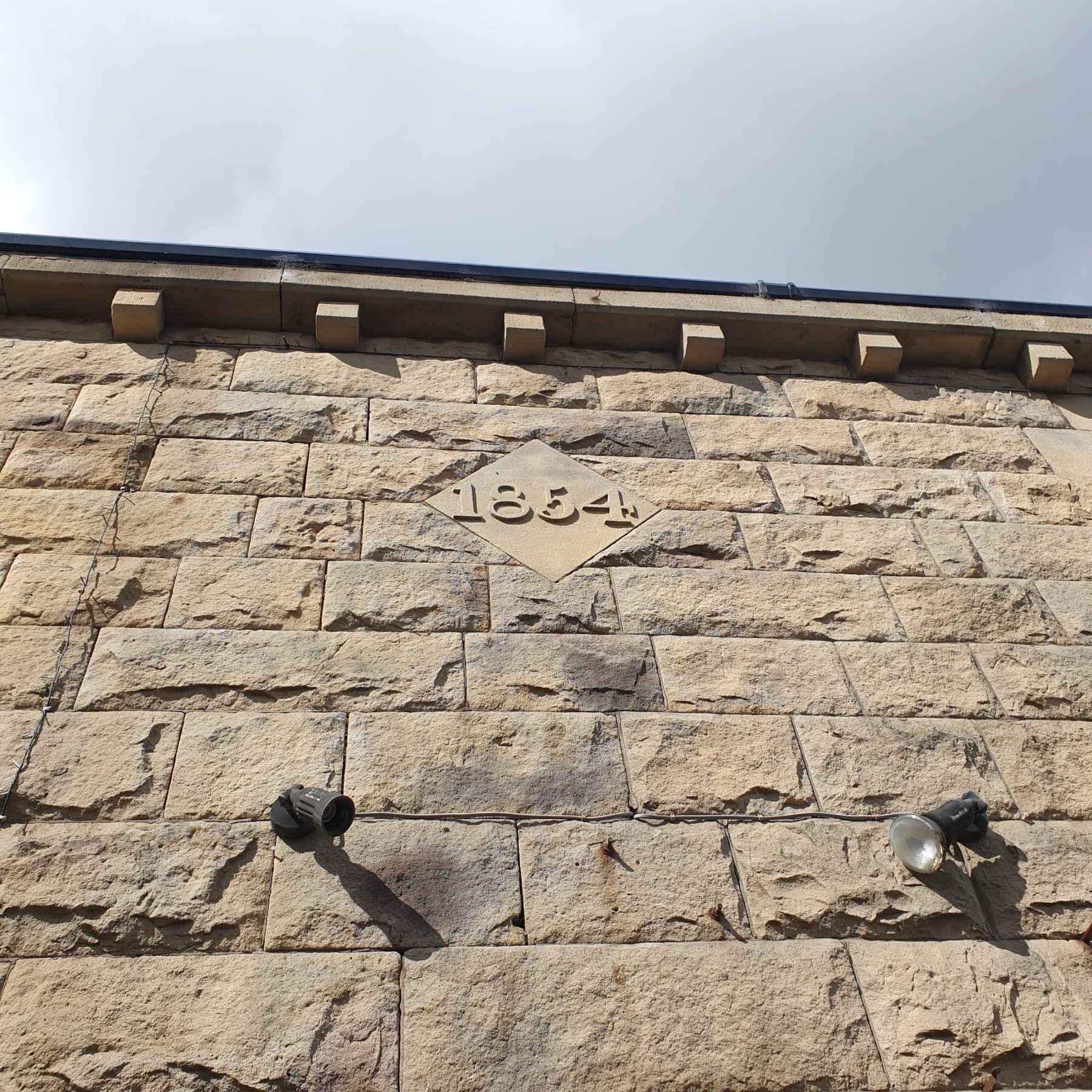 Detail of 1854 monogram on a building on Bridge Street