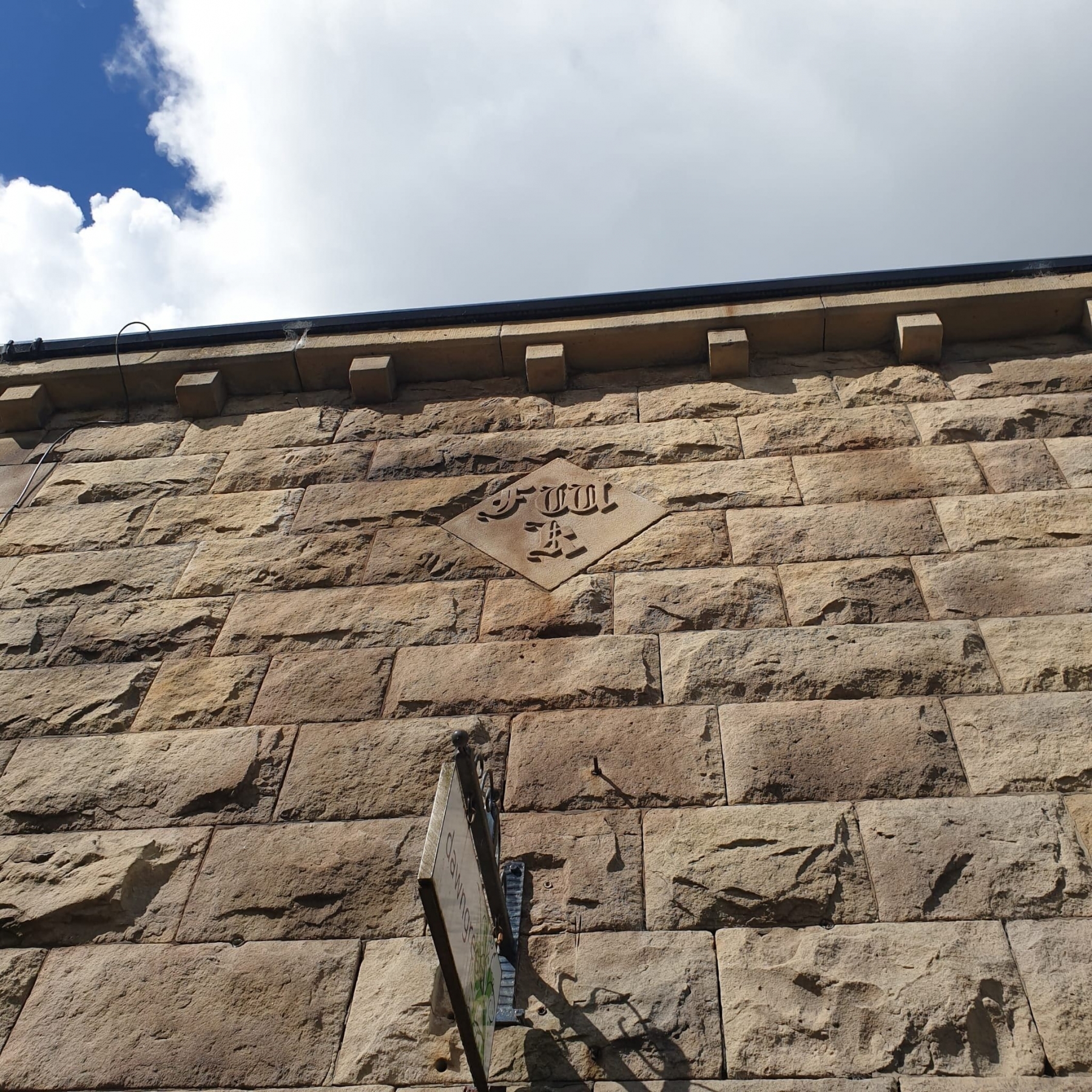 Detail of F.W.K. monogram on a building on Bridge Street